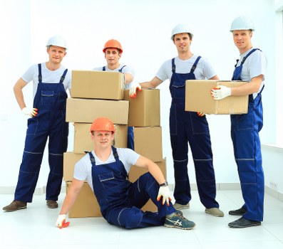 Movers handling boxes and furniture in a beach town setting