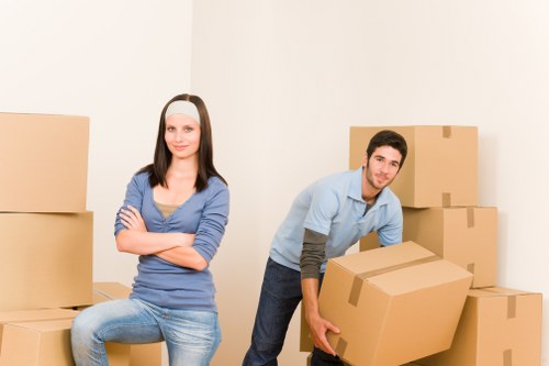 Professional movers carrying household items from a Nags Head property